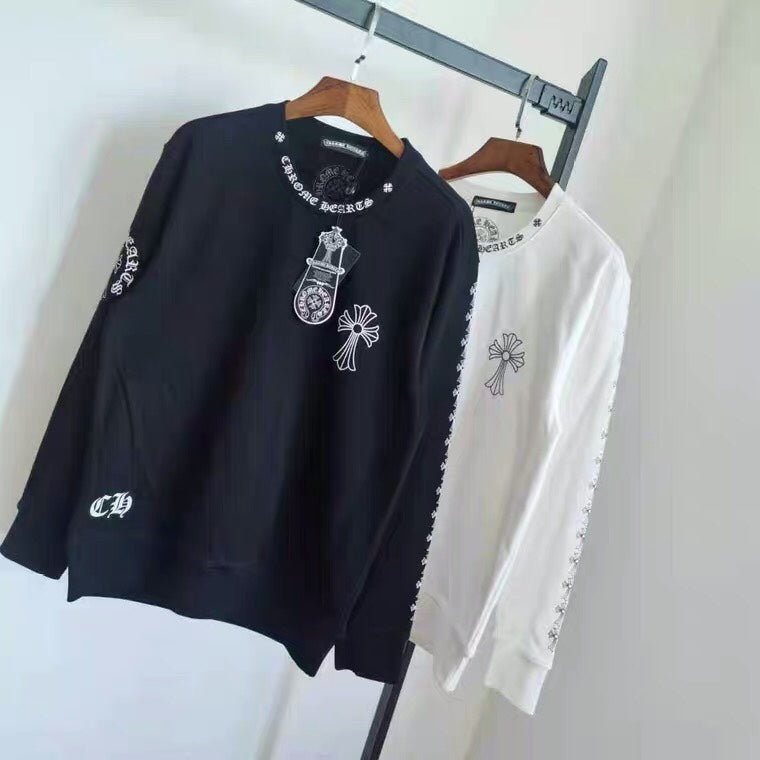 Black and white long-sleeve sweatshirts with cross graphic and sleeve print on hangers