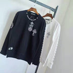 Black and white long-sleeve sweatshirts with cross graphic and sleeve print on hangers