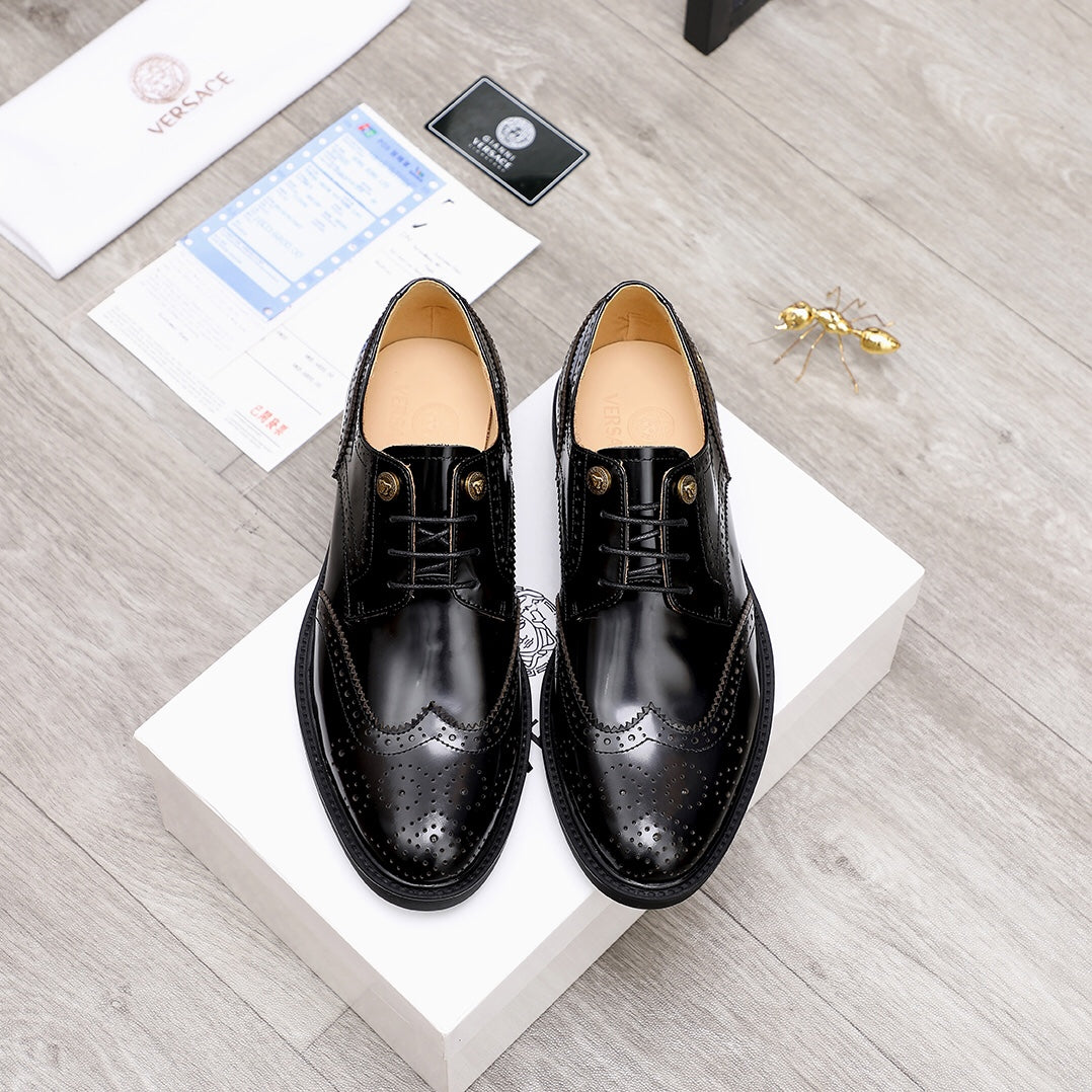 Versace black lace-up oxford shoes with tan lining, on white display boxes