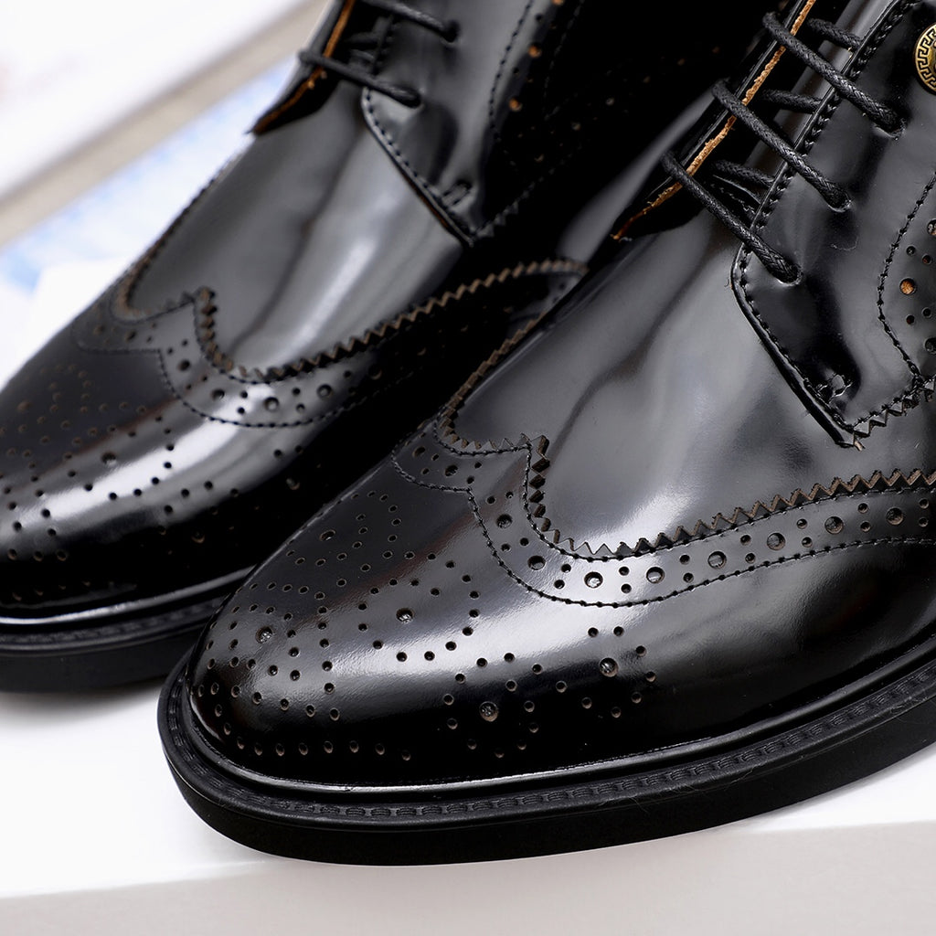 Versace black oxford shoes close-up showing wingtip brogue and perforations
