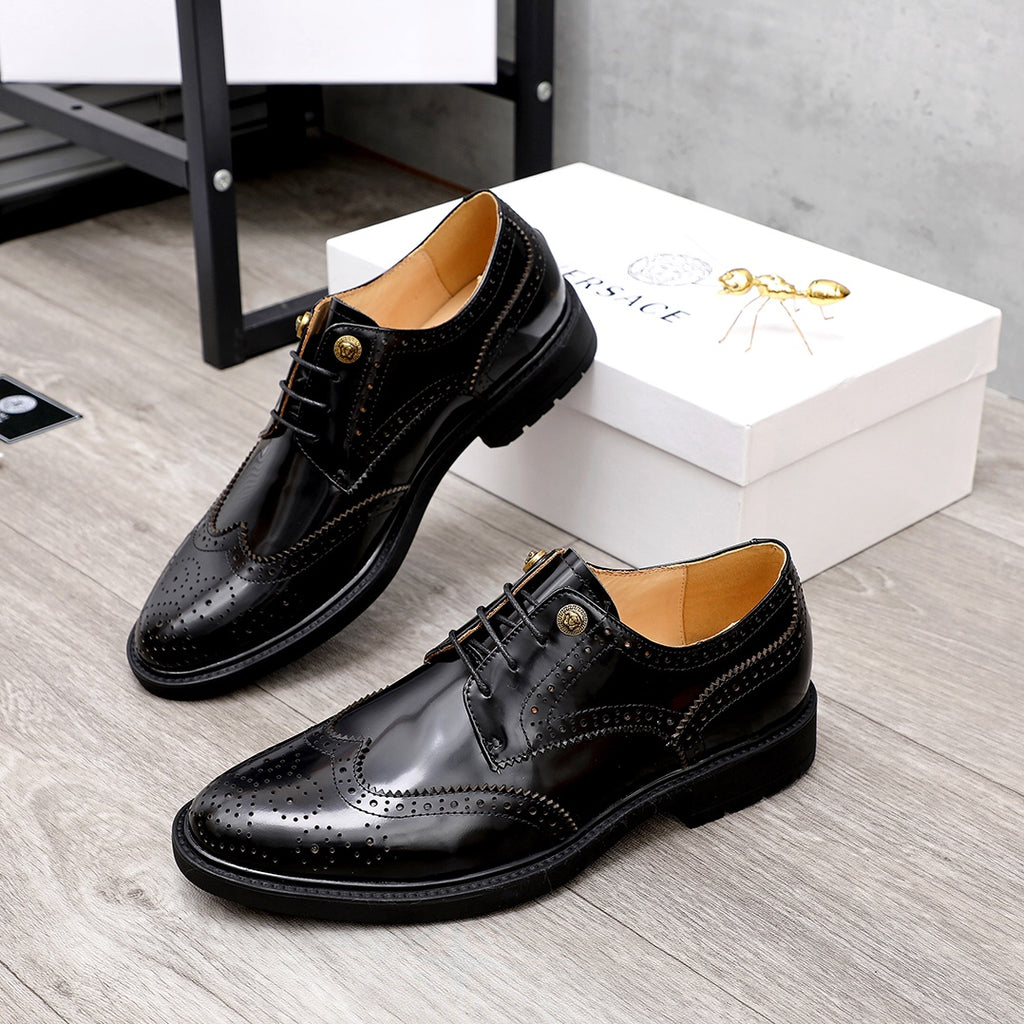 Versace pair of black oxford shoes with lace-up design and gold logo buttons