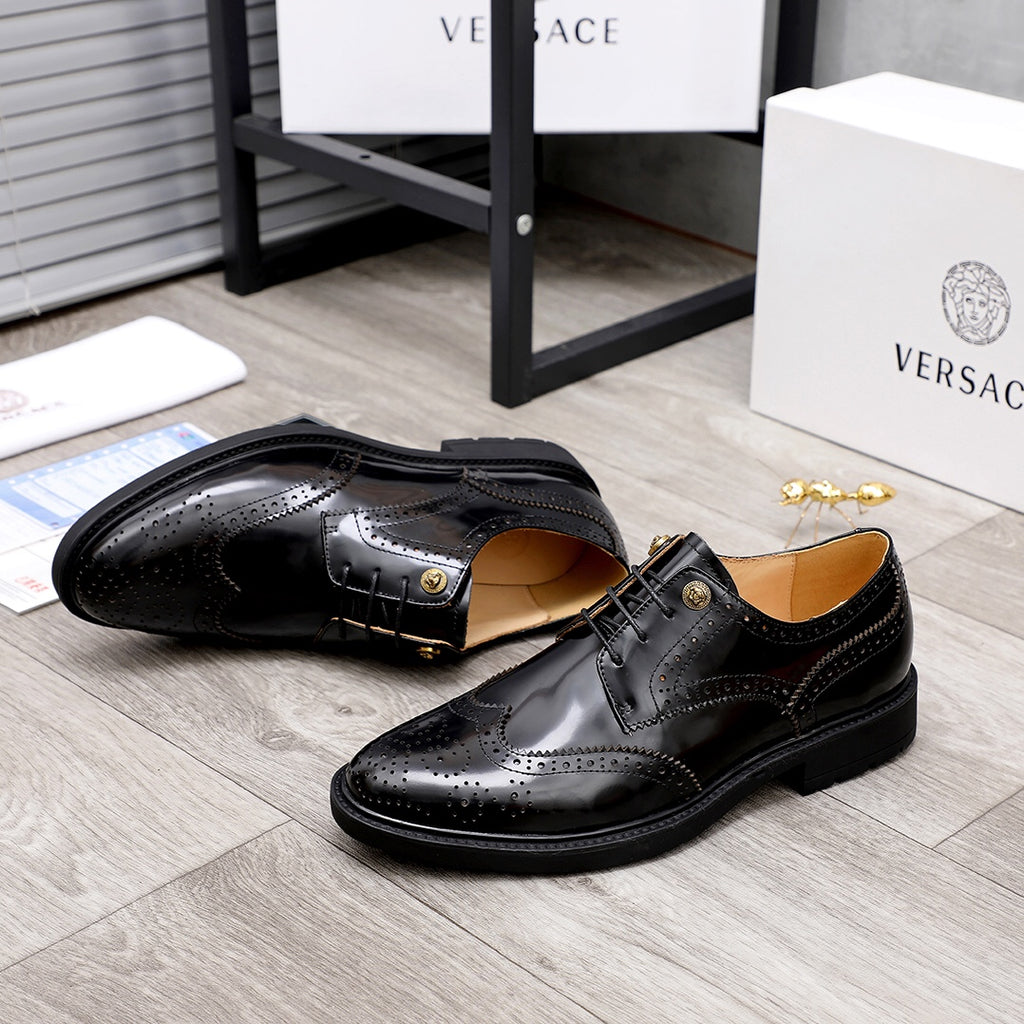 Versace black oxford shoes with wingtip detailing and gold-tone buckle