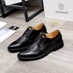 Versace black oxford shoes with wingtip brogue and gold-tone buckle detail