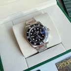 Rolex Submariner watch with black dial and stainless steel bracelet