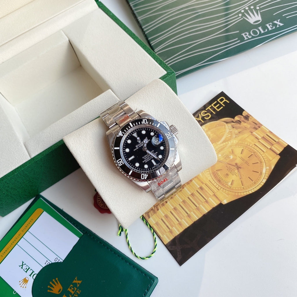 Rolex Submariner watch with black dial and stainless steel bracelet on display cushion