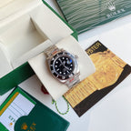Rolex Submariner watch with black dial and stainless steel bracelet on display cushion