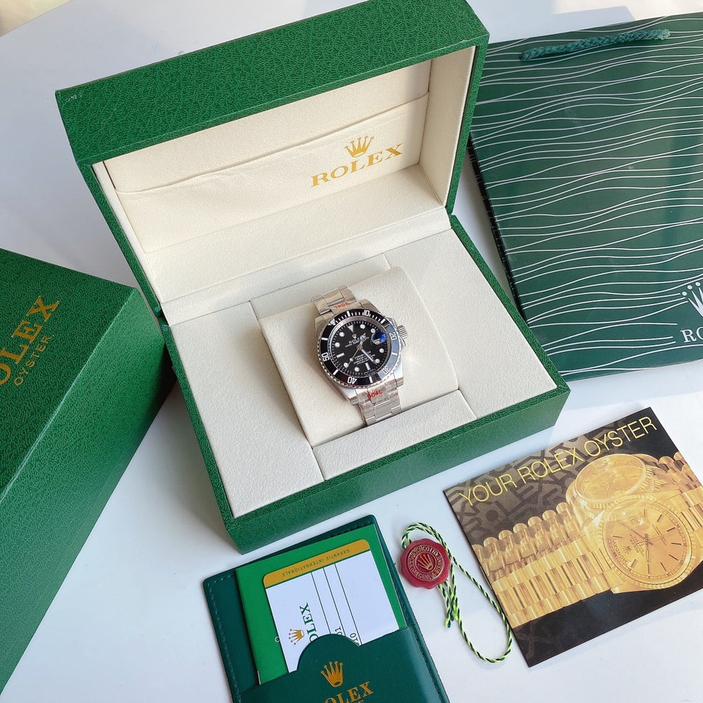 Rolex Submariner watch with black dial and stainless steel bracelet, shown in box