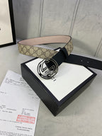 Gucci belt with GG monogram canvas outer band and black leather center strap, large buckle.