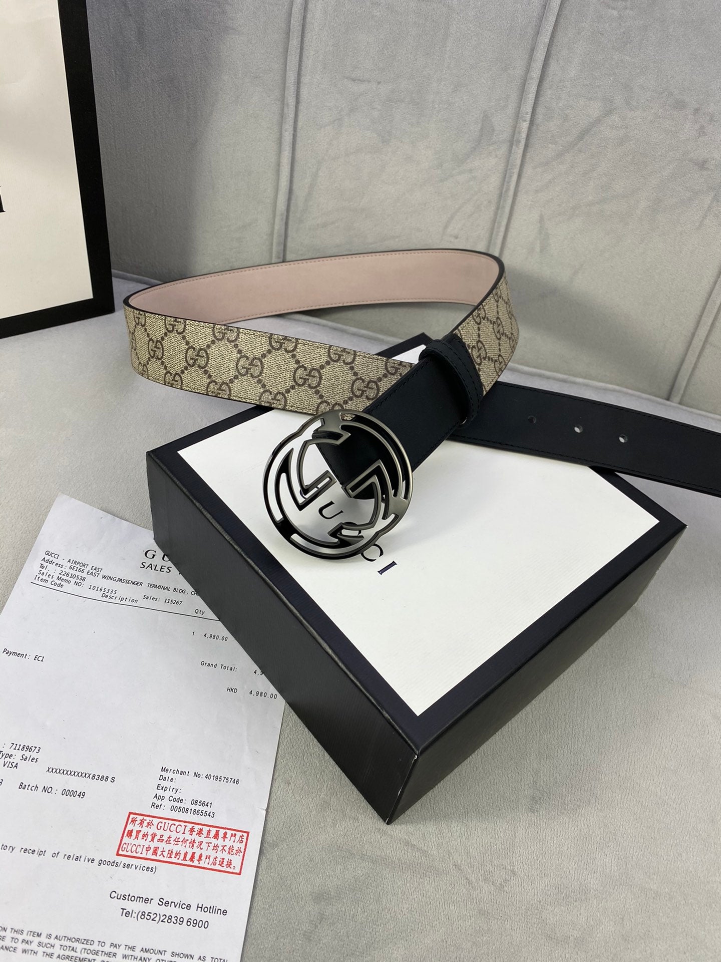 Gucci belt with GG monogram canvas outer band and black leather center strap, large buckle.