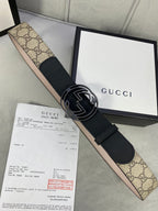 Gucci belt with black leather strap, interlocking G buckle, and GG monogram canvas panel.