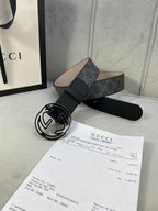 Black GG monogram belt with silver interlocking logo buckle and adjustable keeper.
