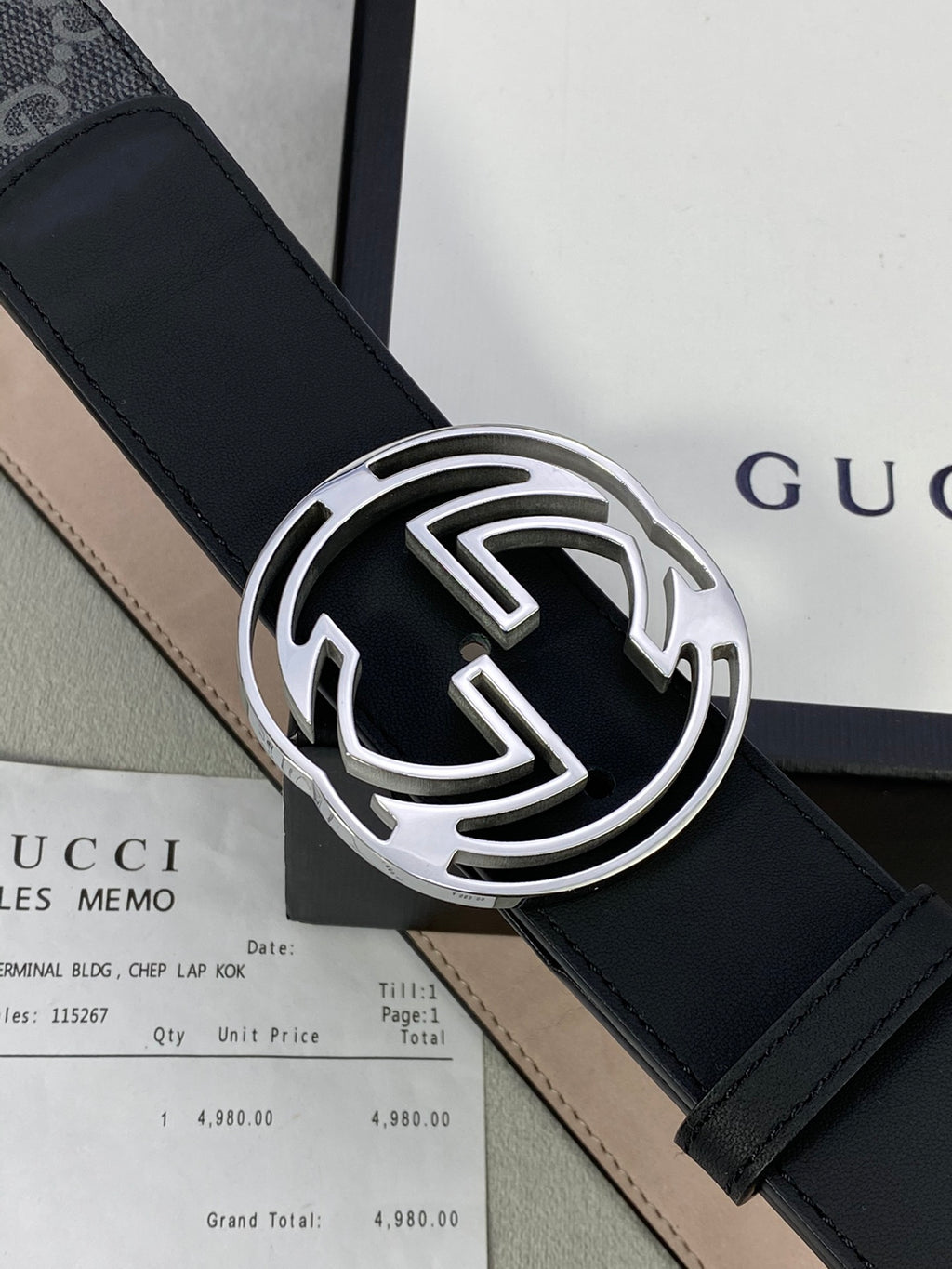 GG monogram belt strap with black leather and large silver interlocking logo buckle.