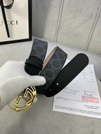 Black GG monogram belt with gold-toned interlocking logo buckle and leather strap ends.