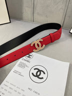 Red leather belt with gold CC-style buckle on black-lined underside