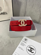 Red leather belt with gold CC-style buckle centered on the strap