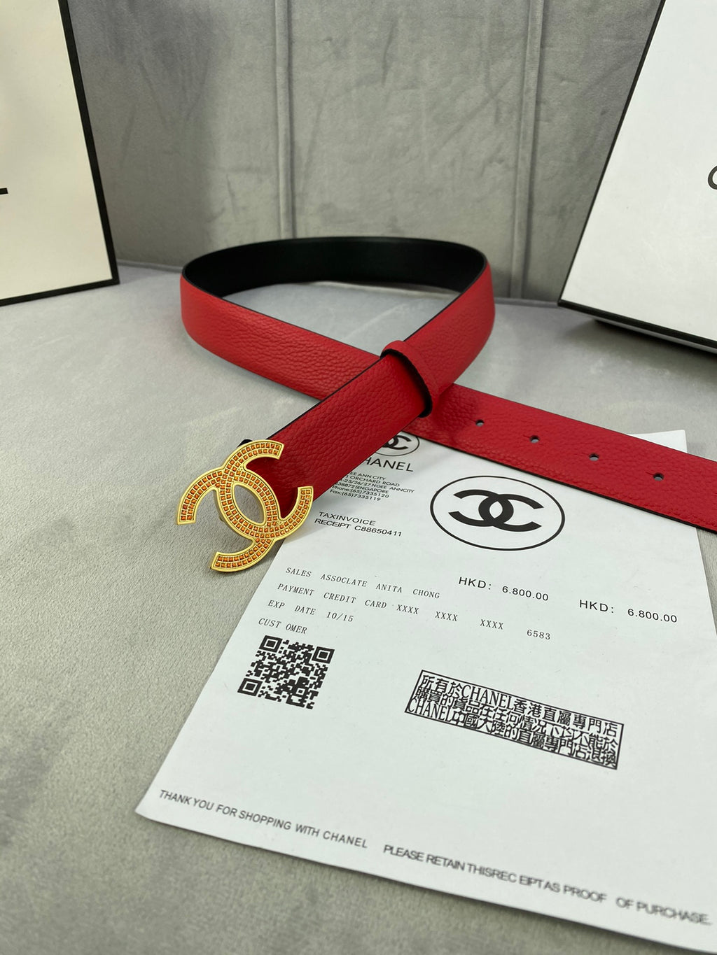 Red leather belt with gold CC-style buckle and adjustable hole strap