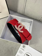 Red leather belt with gold CC-style buckle on a curved strap with holes