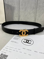 Black leather belt with gold CC logo buckle, straight edge and punched adjustment holes.