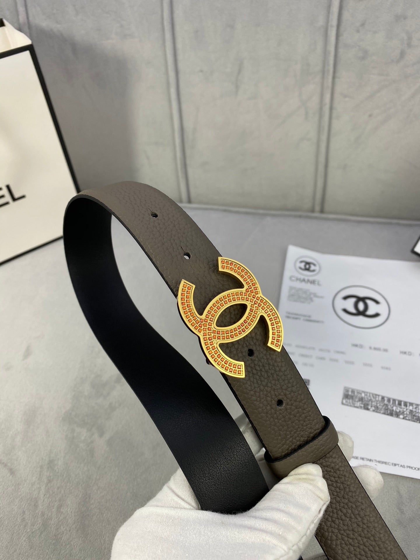 Chanel leather belt from side angle with dark taupe strap and gold CC buckle