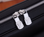 Louis Vuitton bag zipper with silver-tone pulls on black leather