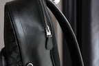 Coah bag side view with smooth black trim and zipper closure