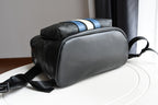 Coah bag with top carry handle, blue-and-white stripe accent, and crossbody strap