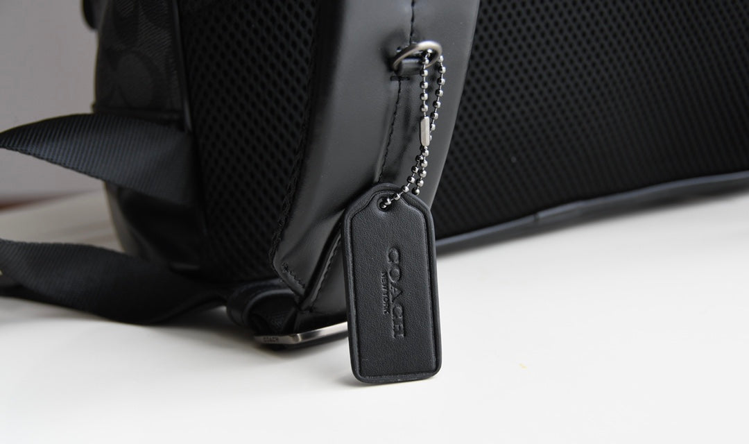 Coah bag close-up of adjustable strap and front corner with zipper pull