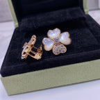 Flower-shaped earrings with gold backings; pastel blue petal hearts and crystal pavé