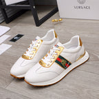 White lace-up sneakers with gold-trim quarter and multicolor logo patch