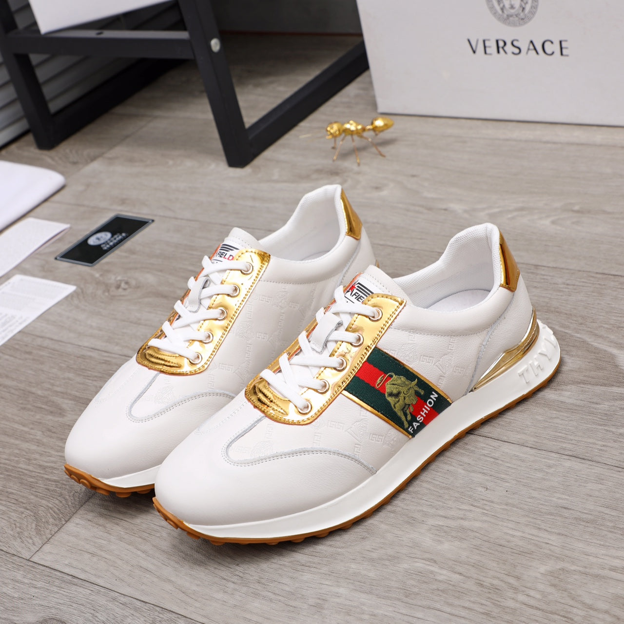 White lace-up sneakers with gold-trim quarter and multicolor logo patch
