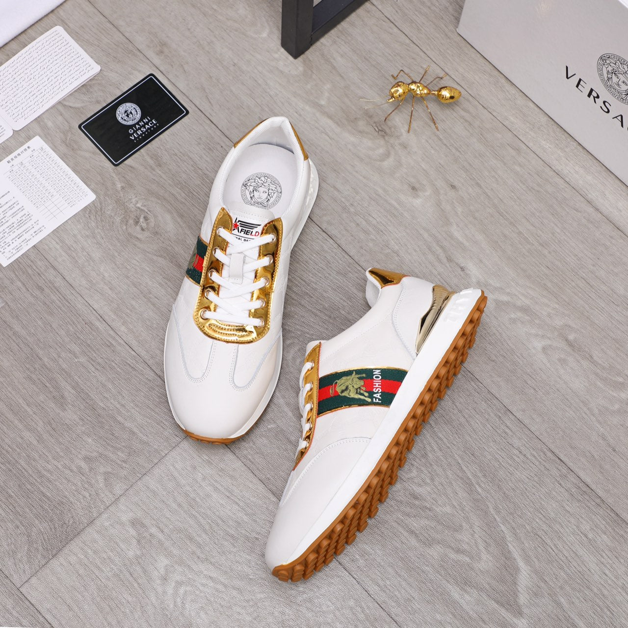 White sneakers, side view, gold-trim laces and multicolor logo patch