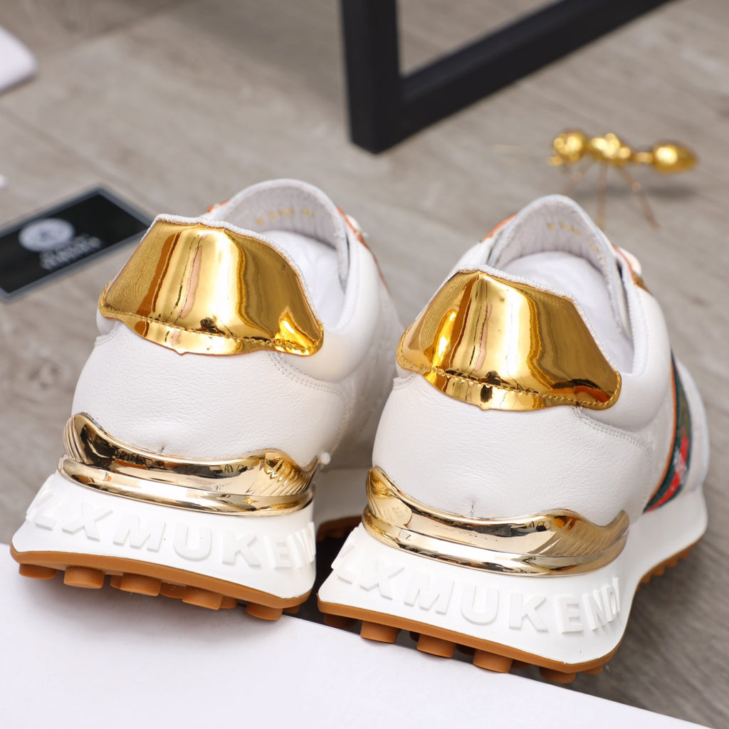 Back view of white sneakers with gold heel caps and rugged outsole