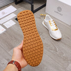 White sneaker outsole with circular tread pattern, held in hand