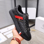 Black Versace low-top lace-up sneakers with embossed logo and red side panel stripe