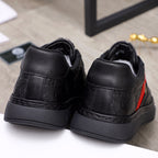 Black Versace sneakers back view with embossed logo and red side stripe detail