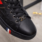 Black Versace lace-up sneakers detail with metal lace charm and side stripe trim