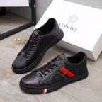 Black Versace lace-up sneakers with monogram texture and red-yellow side stripe