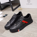 Black Versace lace-up sneakers with embossed logo pattern and side color stripe