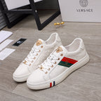 White Versace sneakers with gold-tone eyelets, multicolor stripe detail, lace-up front