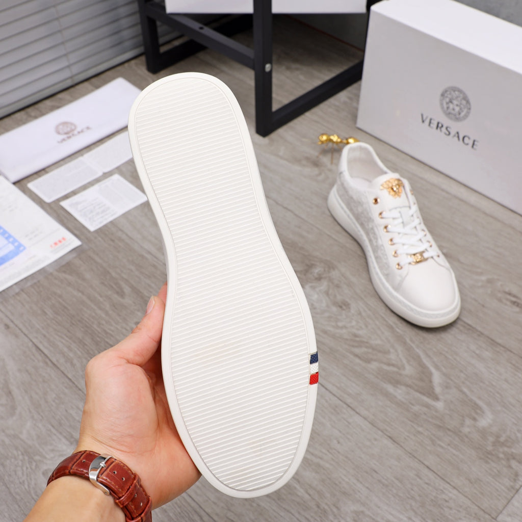 White sneaker outsole view with ribbed tread and rear side panel