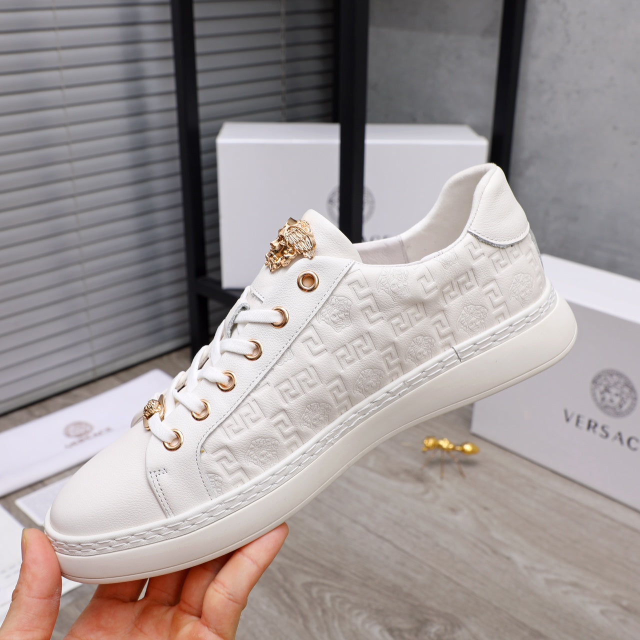 White Versace low-top sneakers with embossed pattern, gold emblem and multicolor stripe