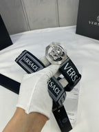 Versace belt with black-and-white logo strap and silver-toned medallion buckle