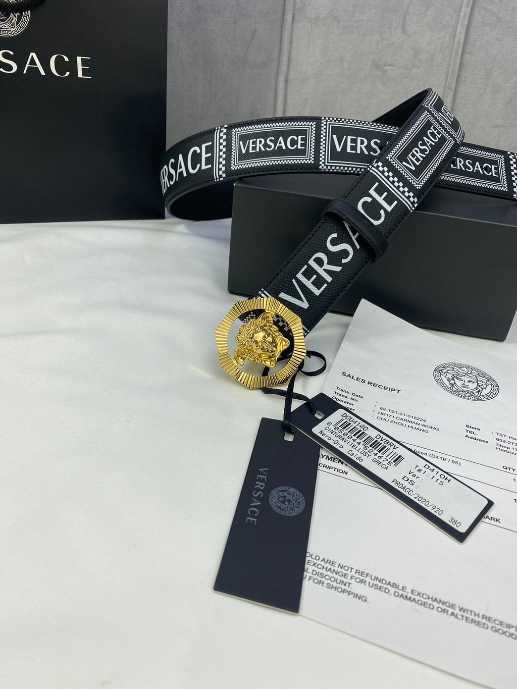 Versace belt in black with logo print and gold-toned medallion buckle, with tags