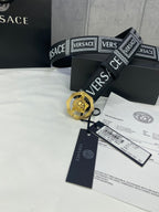 Versace belt in black with logo print and gold-toned medallion buckle, with tags