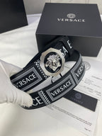 Versace belt close-up in black with logo strap and silver-toned medallion buckle