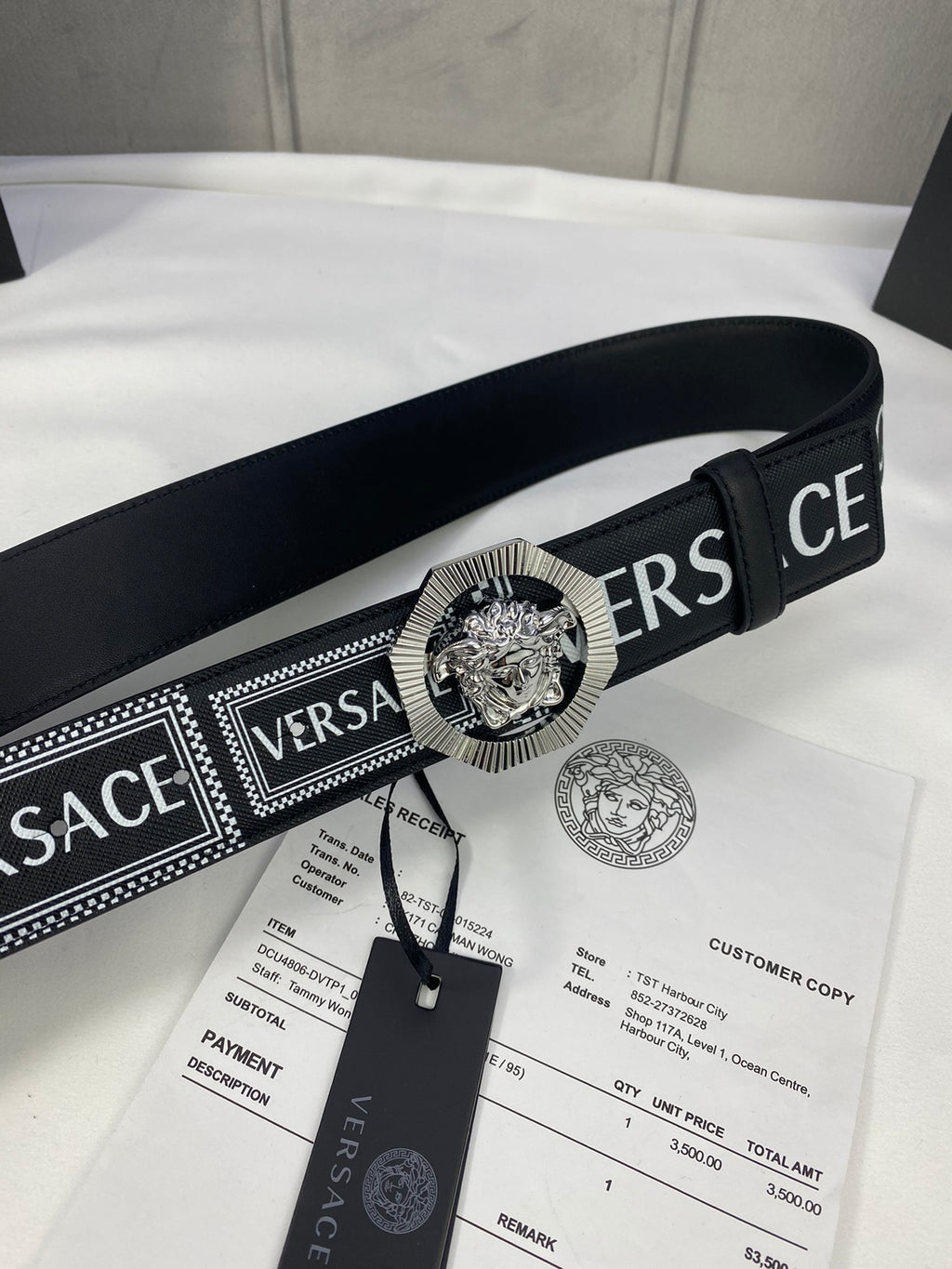 Versace belt in black with patterned strap and silver-toned medallion buckle, with tag