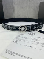 Versace belt laid flat in black with logo weave and silver-toned medallion buckle