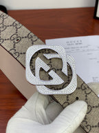 Gucci belt extreme close-up: beige GG canvas with silver-tone crystal double G buckle