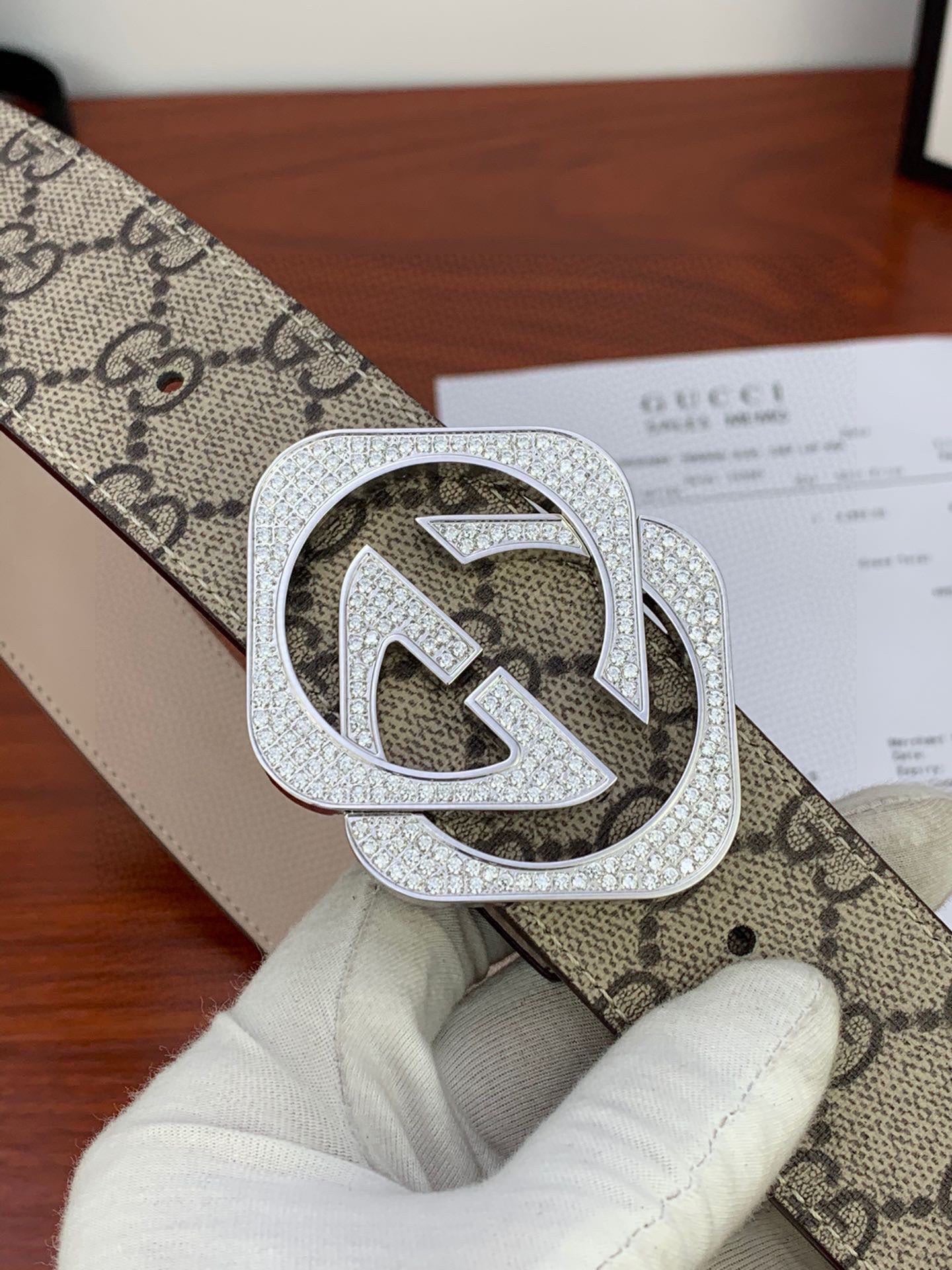 Gucci belt extreme close-up: beige GG canvas with silver-tone crystal double G buckle