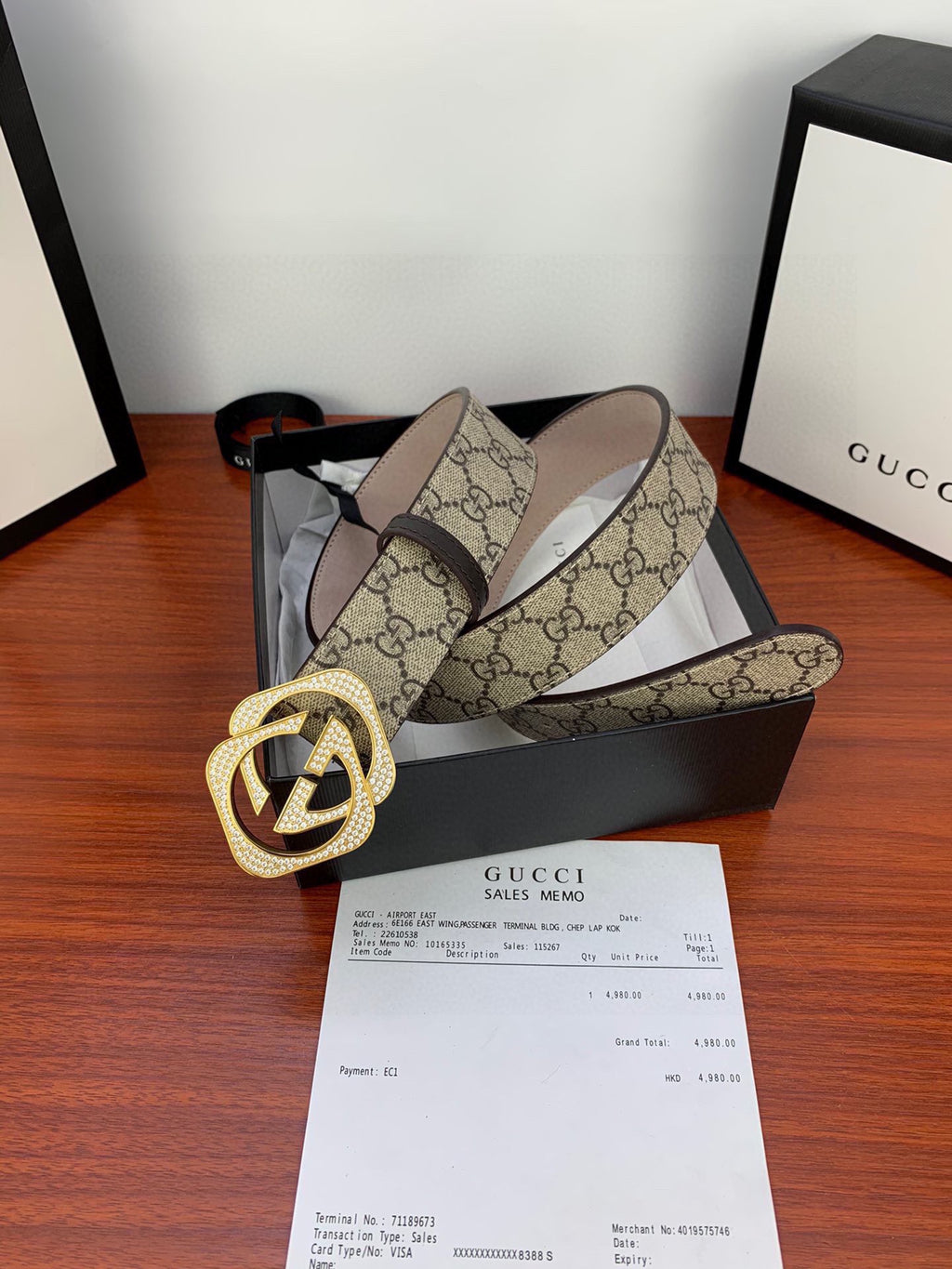 Gucci belt on display: beige GG canvas with gold-tone double G buckle